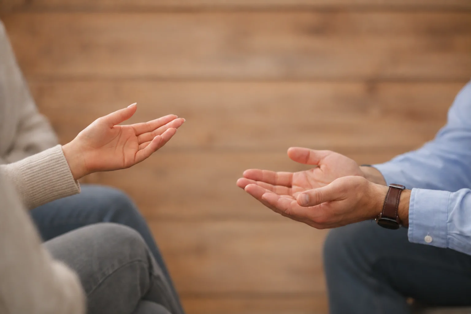 Illustration of two people sharing a conversation, shown through their hand gestures